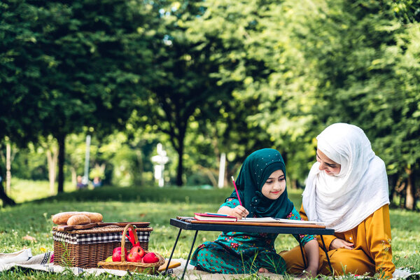 Portrait of happy muslim mother and little muslim girls child le