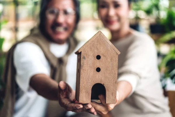 Happy family senior adult elderly asia couple holding house in h — Stock Photo, Image