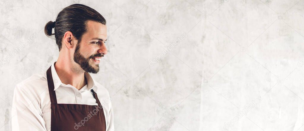 Portrait of handsome bearded barista man small business owner working in a cafe