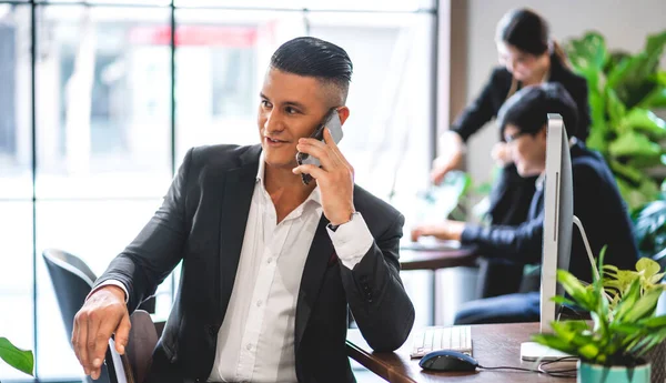 Handsome hipster business man relaxing using digital smartphone at table in cafe and restaurant,playing game online and social media