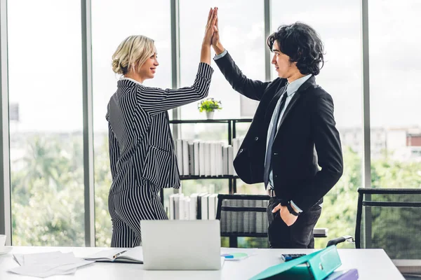 Group of successful people giving hi five together