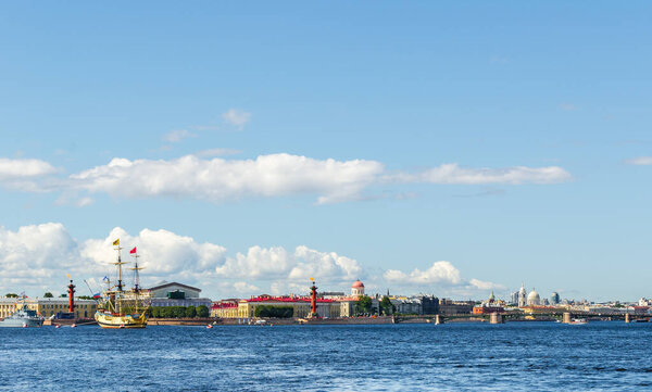 Panorama of the embankment in St. Petersburg, with people on the streets, the arrow of Vasilievsky island, the stock exchange, bridges, Rostral columns, a warship, a sailing ship, on a sunny summer day