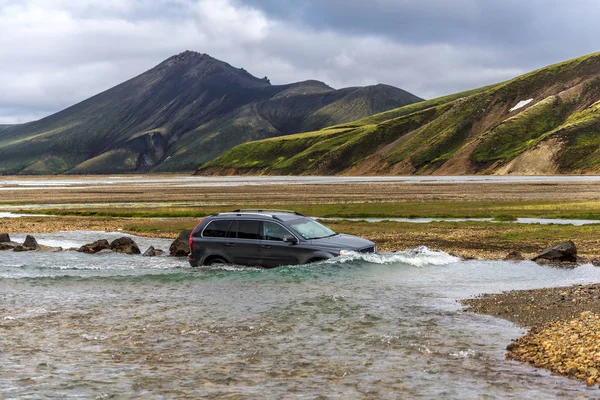 Car crossing Jokulgilskvisl river flow in Fridland ad Fjallabaki