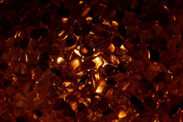 Amber grains with backlight illumination — Stock Photo, Image