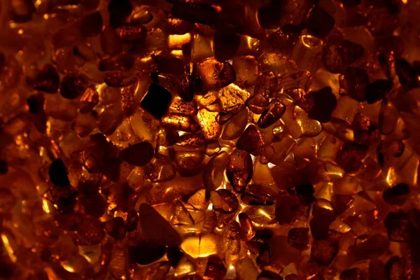 Amber grains with backlight illumination — Stock Photo, Image