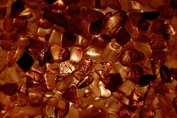 Amber grains with backlight illumination — Stock Photo, Image