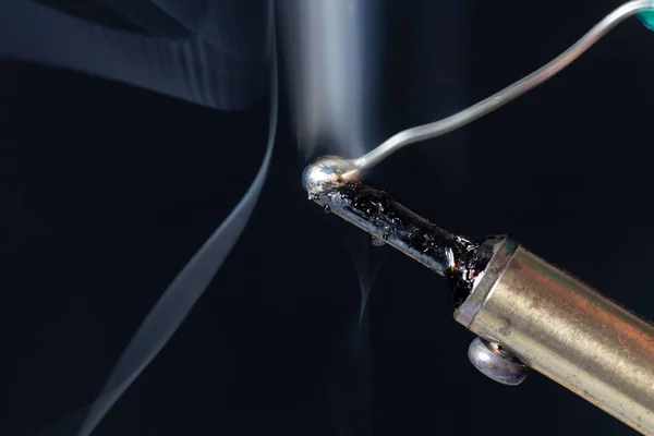 Melting tin on the tip of a soldering iron — Stock Photo, Image