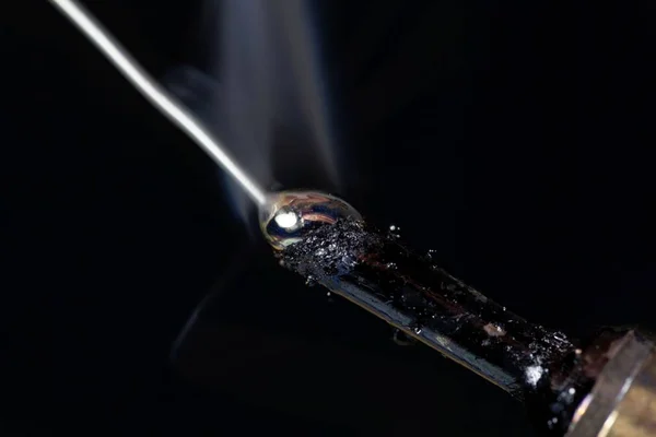 Melting tin on the tip of a soldering iron — Stock Photo, Image