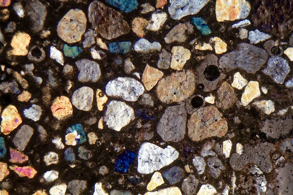 Thin section of concrete under a microscope and in cross polarized light — Stock Photo, Image
