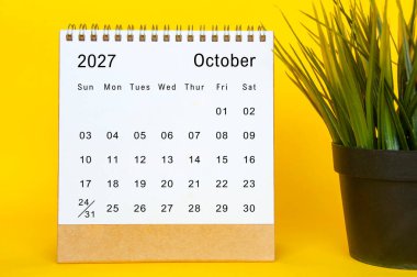 Ekim 2027 düzenli takvim şablonu sarı tahta çerçeve, beyaz sayfa tasarımı ve küçük bitki