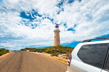 Cape Du Couedic lighthouse under beautiful sky by the road with  clipart