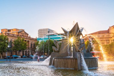 Adelaide, Australia, January 2, 2022: Three Rivers Fountain with sun rays shining through at sunset in Victoria Square, Adelaide CBD