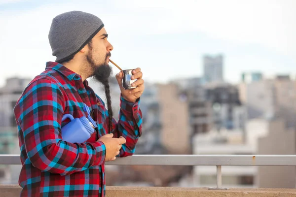 Bearded man drinking mate in Buenos Aires city