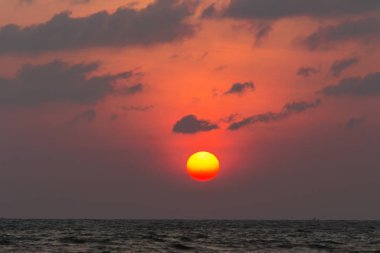 Büyük güneş kırmızı turuncu ve siyah bulutlar yağmur mevsimi başlamak.