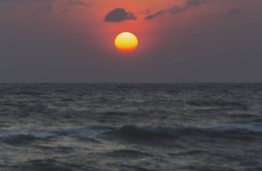 Büyük güneş kırmızı turuncu ve siyah bulutlar yağmur mevsimi başlamak.