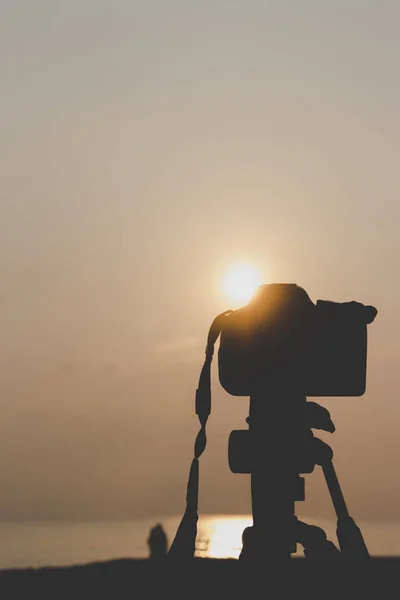 silhouette, camera and nature by the sea.