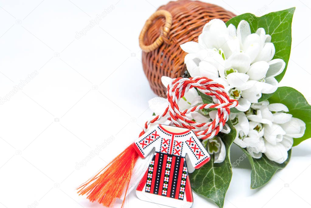 snowdrops and red and white string martisor on white with copy space east european first of march tradition celebration