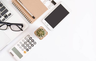 Beyaz ofis resepsiyon masası, dizüstü bilgisayar, smartphone siyah ekran, kalem, hesap makinesi, gözlük ile çalışma alanı office, Top kopya alanı görünümüyle