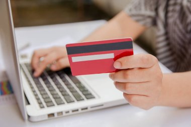 kredi kartı tutan ve online ödeme online, online alışveriş yapma dizüstü kullanarak kadın el