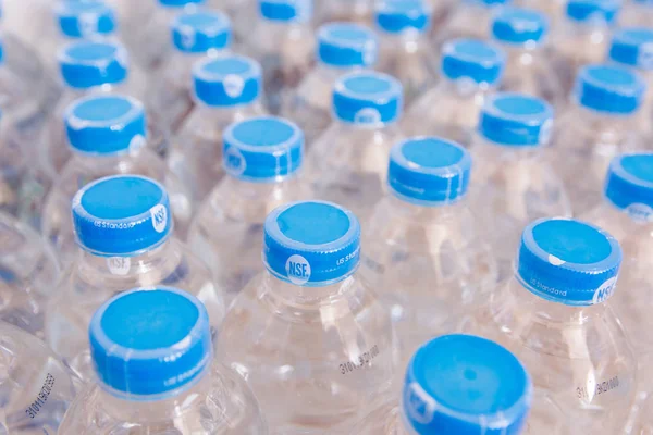 Rows of water plastic bottles and cap seal NSF us standard