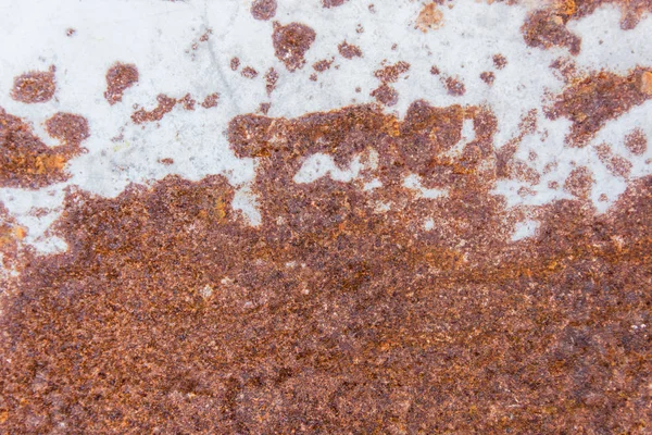 Brown rust stains texture of the old white paint on rusty metal wall. Rusty metal background.