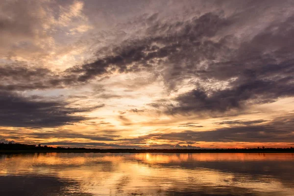 stock image Sunset in the lake. beautiful sunset behind the clouds above the over lake landscape background. dramatic sky with cloud at sunse