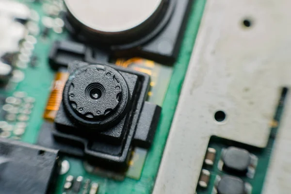 Close up camera inside electronic circuit board smart phone. disassembled cell phone parts.