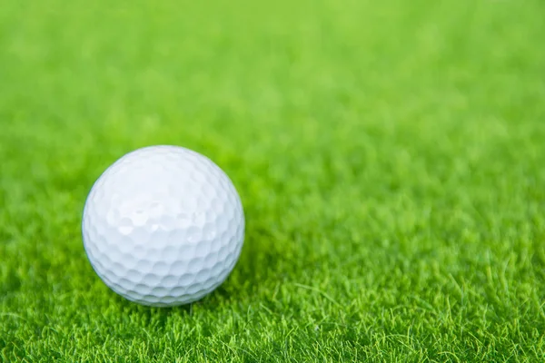 Golf ball on green grass ready to play at golf course. with copy