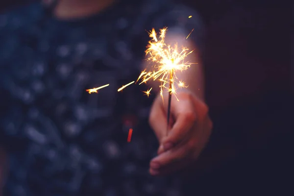 Christmas, New year sparkler in woman hands. — Stock Photo, Image