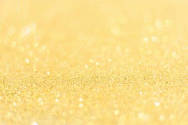 Odaklanmamış altın parıltısı arka planı. Altın soyut bokeh geri gruplandırması