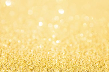 Odaklanmamış altın parıltısı arka planı. Altın soyut bokeh geri gruplandırması