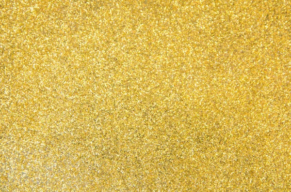 Defokussiert Goldglitzerhintergrund. Gold abstrakter Bokeh-Hintergrund — Stockfoto