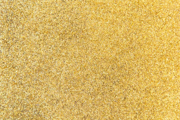 Defocused gold glitter background. Gold abstract bokeh backgroun
