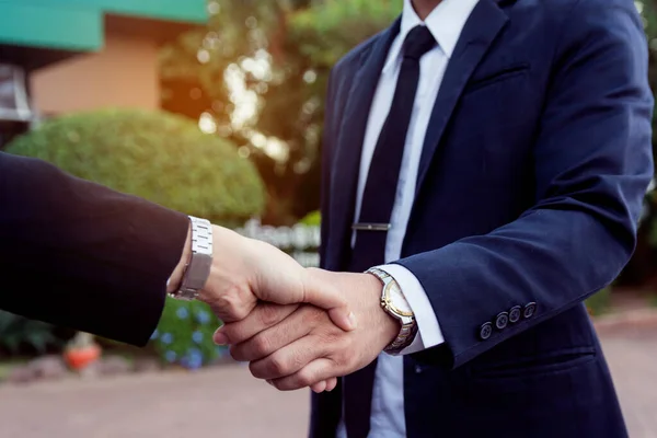 Businessman and woman shake hands after a business meeting