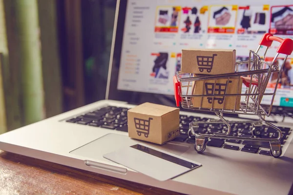 Shopping online concept - Parcel or Paper cartons with a shoppin — Stock Photo, Image