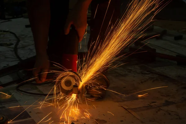 Electric wheel grinding cuting on steel. sparks from cutting — Stock Photo, Image