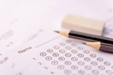 Pencil and eraser on answer sheets or Standardized test form wit clipart