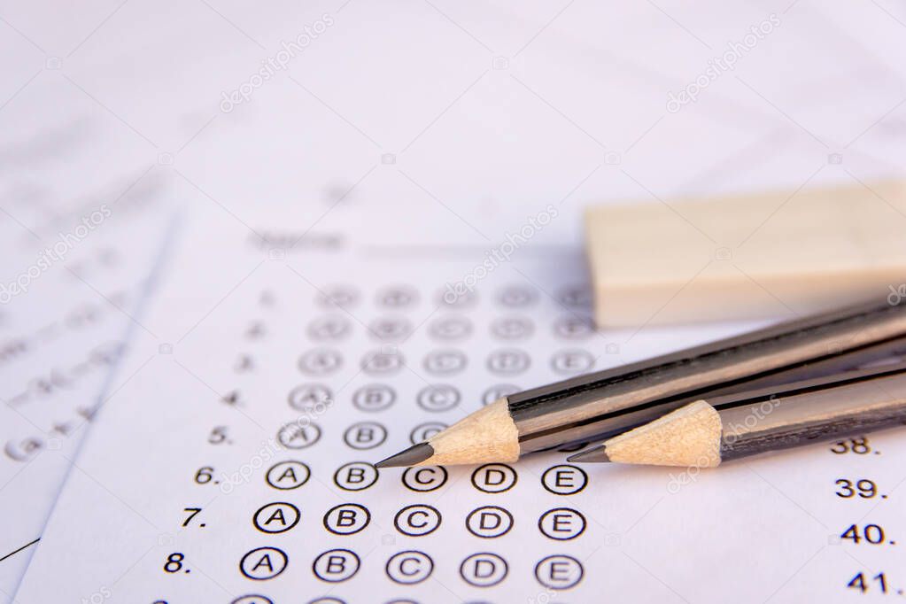 Pencil and eraser on answer sheets or Standardized test form wit