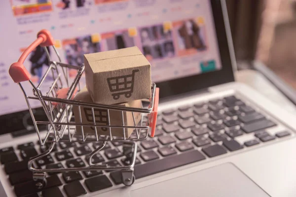 Shopping online concept - Parcel or Paper cartons with a shoppin