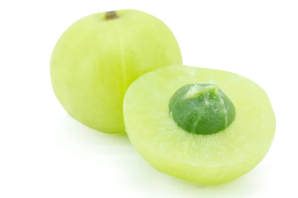 Snijd Indiase kruisbes, amla groene vruchten geïsoleerd op witte bac — Stockfoto