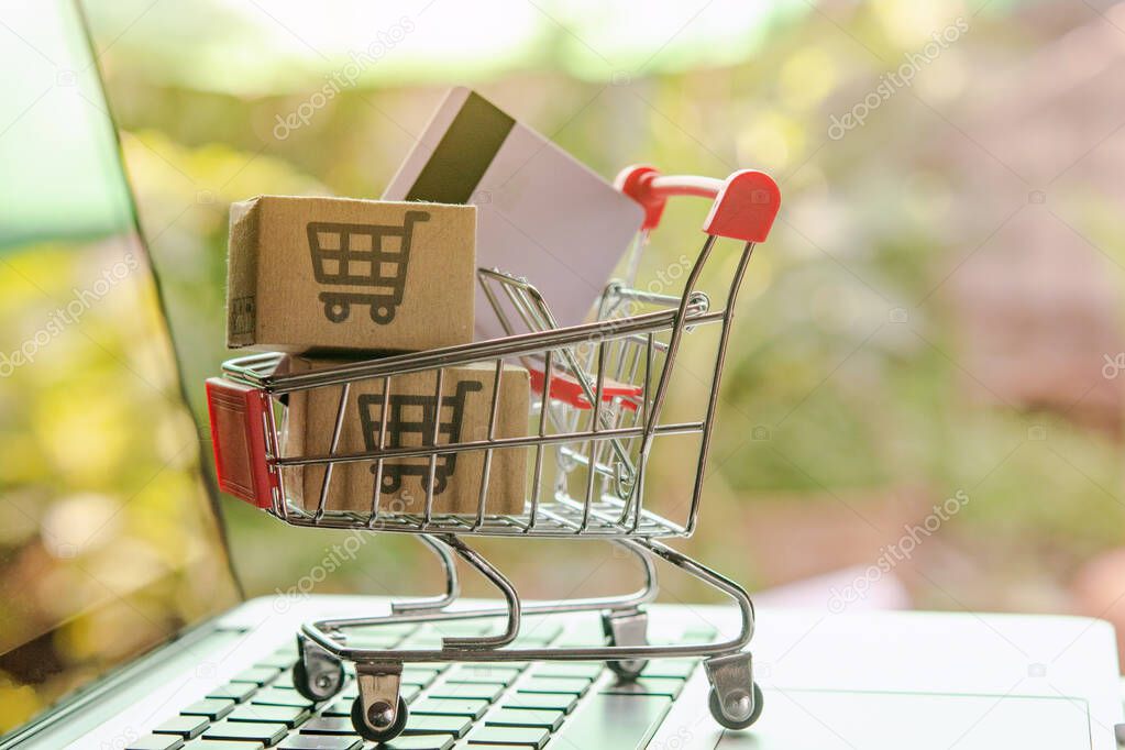 Shopping online concept - Parcel or Paper cartons with a shoppin
