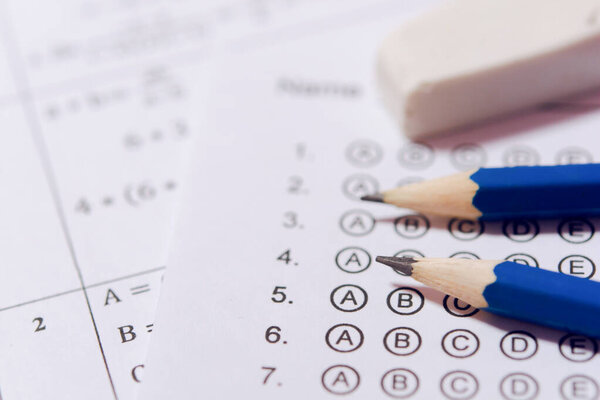 Pencil and eraser on answer sheets or Standardized test form wit