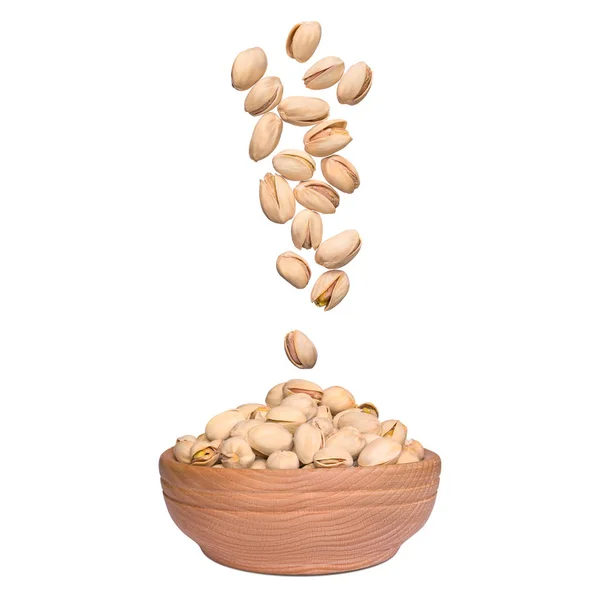 Pistachio in bowl on white background. Nuts falling to wooden bowl — Stock Photo, Image