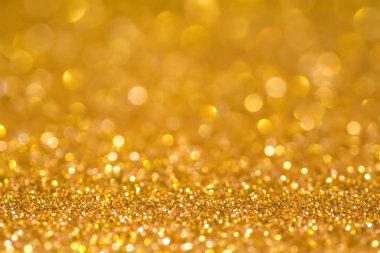 Altın pul parlak parlaklık. Sarı tozu. Glitter ve bokeh ışıklar