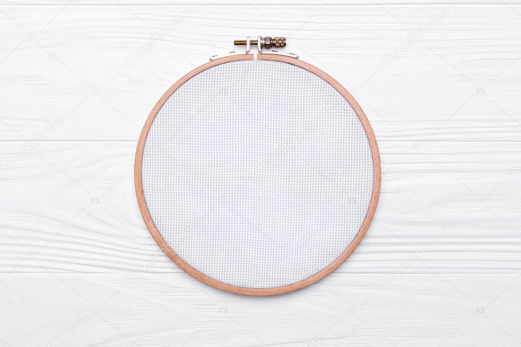 Tools for cross stitch. A hoop for embroidery and canvas on white
