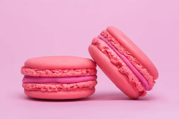 Two pink macaron cookies on a pink background — Stock Photo, Image