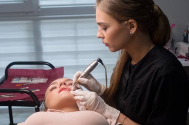Permanent make up procedure. Lip makeup in tattoo salon clipart