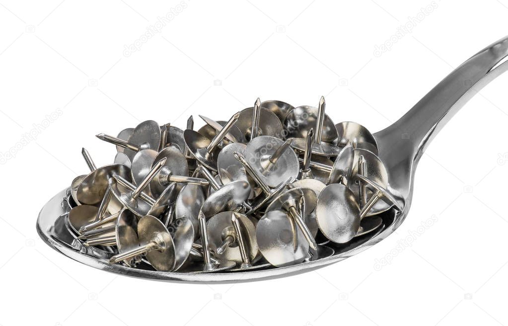 A spoon full of drawing pins (or thumb tack) as a symbol of health fraud. Quackery is the promotion of fraudulent or ignorant medical practices.