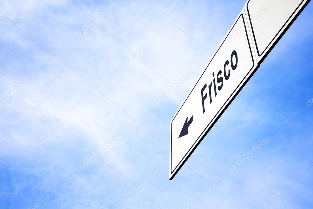 White signboard with an arrow pointing left towards Frisco, Texas, USA, against a hazy blue sky in a concept of travel, navigation and direction. Path included for the signboard