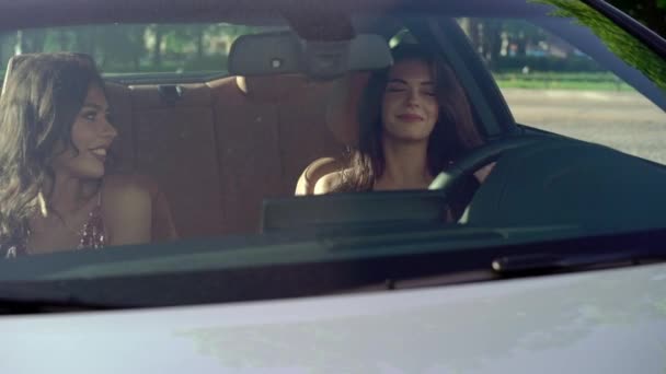 Two young woman sitting in luxury sports car — Stock Video